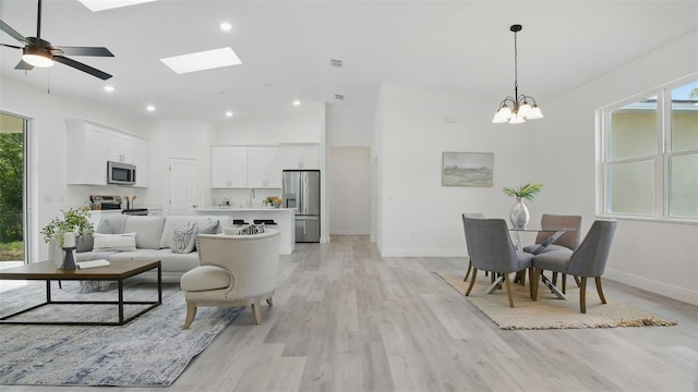 17 Cypress Run, Haines City, FL 33844 - living area featuring plenty of natural light, light wood-style flooring, a chandelier, high vaulted ceiling, and recessed lighting