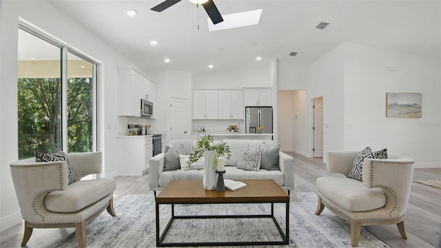 17 Cypress Run, Haines City, FL 33844 - living room featuring a ceiling fan, a skylight, recessed lighting, light wood-type flooring, and high vaulted ceiling