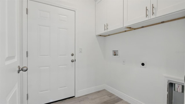 17 Cypress Run, Haines City, FL 33844 - washroom with light wood finished floors, cabinet space, hookup for a washing machine, and hookup for an electric dryer