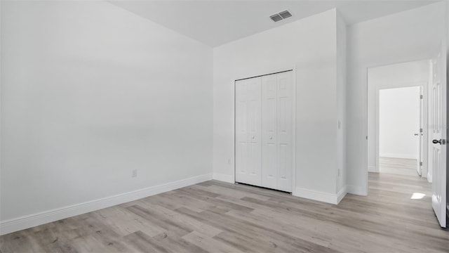 17 Cypress Run, Haines City, FL 33844 - unfurnished bedroom featuring light wood-style floors and a closet