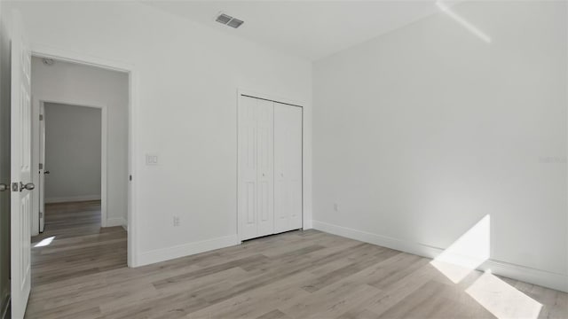 17 Cypress Run, Haines City, FL 33844 - unfurnished bedroom with light wood-type flooring and a closet