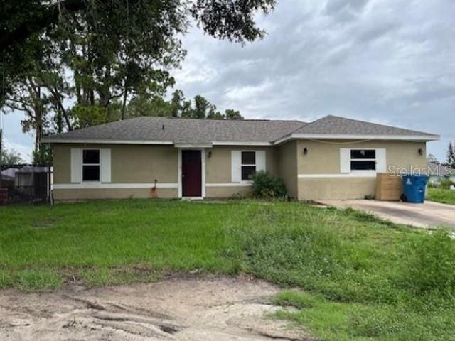 1305 Deedra St NW, Palm Bay, FL 32907 - ranch-style house featuring stucco siding and a front lawn