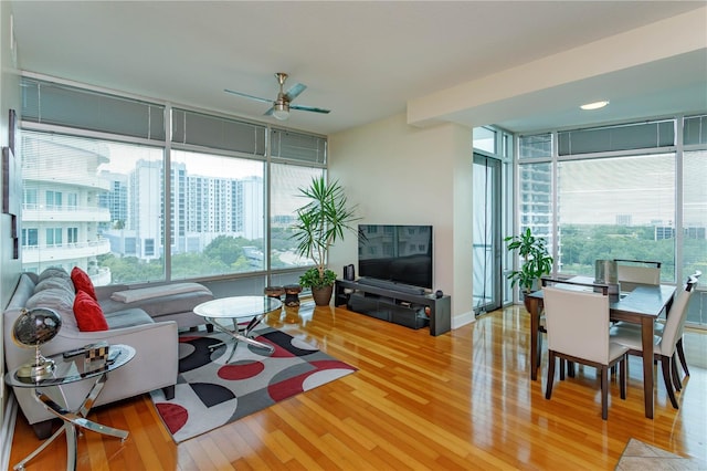 101 S Eola Dr Unit 1021, Orlando, FL 32801 - living area featuring wood finished floors, ceiling fan, and a wall of windows