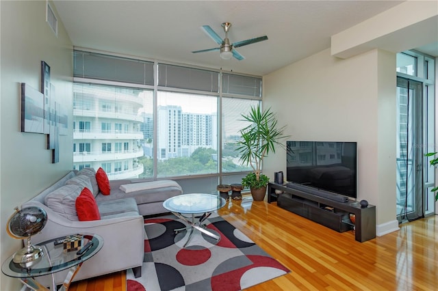 101 S Eola Dr Unit 1021, Orlando, FL 32801 - living area with a ceiling fan, plenty of natural light, and wood finished floors