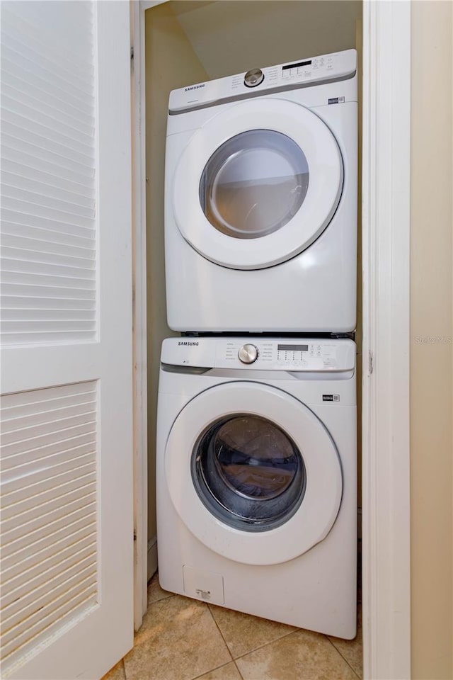 101 S Eola Dr Unit 1021, Orlando, FL 32801 - laundry room with stacked washing machine and dryer and light tile patterned floors