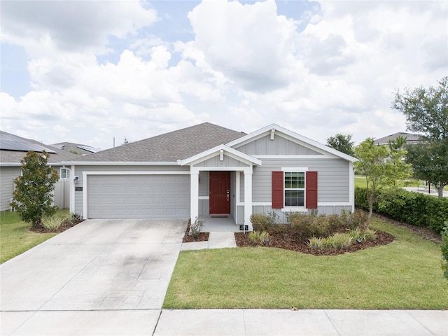 561 Andrea Cir S, Haines City, FL 33844 - ranch-style house with a garage, driveway, a front lawn, board and batten siding, and roof with shingles