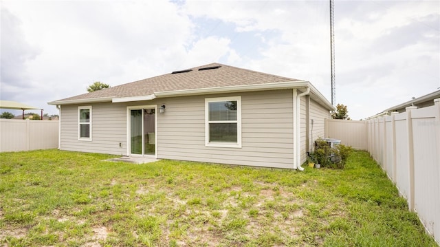 561 Andrea Cir S, Haines City, FL 33844 - back of property featuring a fenced backyard and roof with shingles
