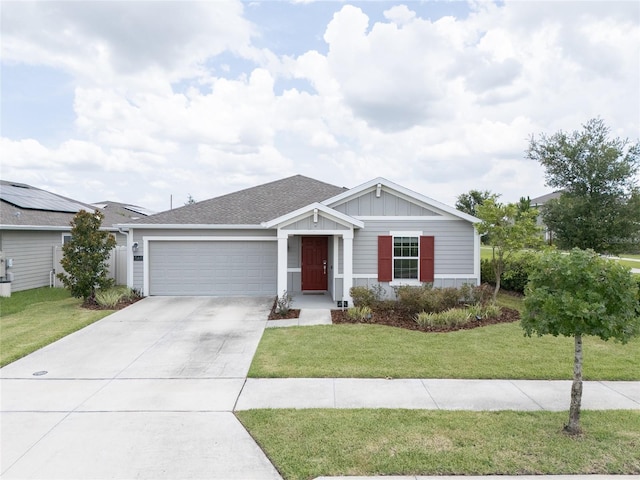 561 Andrea Cir S, Haines City, FL 33844 - ranch-style home with a garage, driveway, a front lawn, board and batten siding, and a shingled roof
