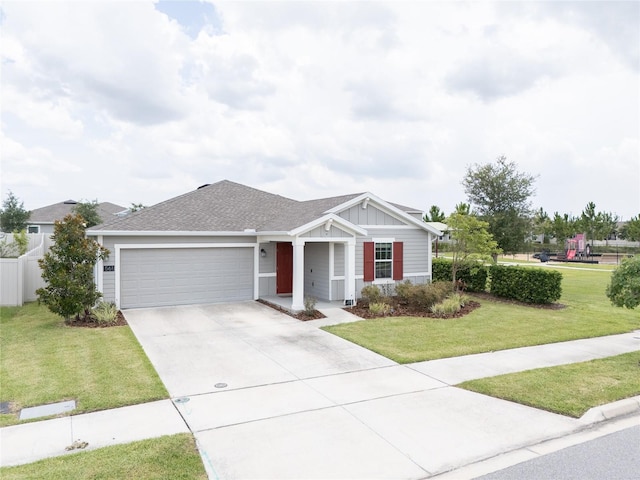 561 Andrea Cir S, Haines City, FL 33844 - ranch-style house featuring an attached garage, driveway, a front lawn, and board and batten siding