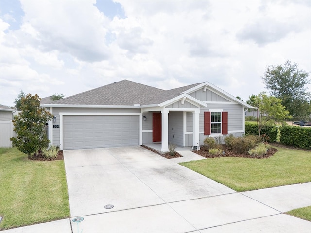 561 Andrea Cir S, Haines City, FL 33844 - single story home with a garage, driveway, board and batten siding, a front yard, and a shingled roof