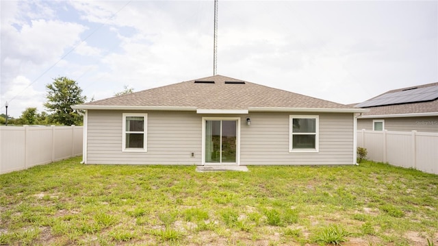 561 Andrea Cir S, Haines City, FL 33844 - rear view of property featuring a fenced backyard and roof with shingles