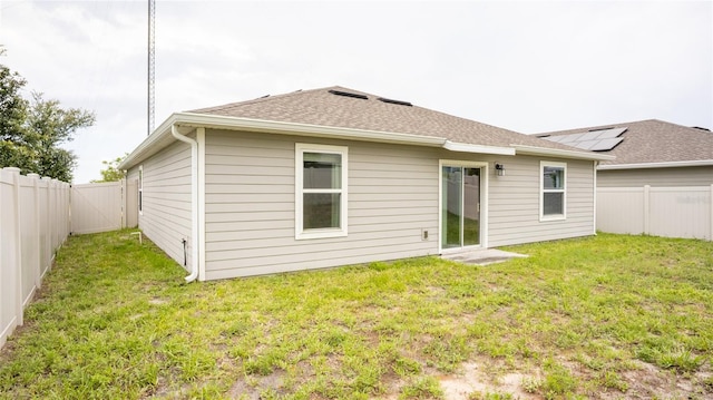 561 Andrea Cir S, Haines City, FL 33844 - back of house featuring a fenced backyard and roof with shingles