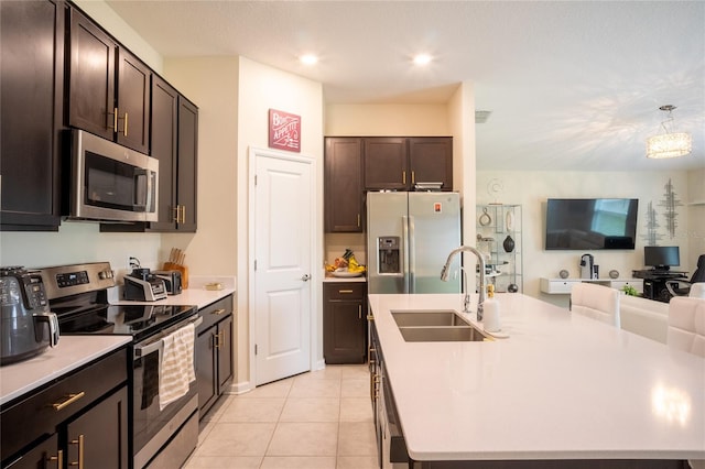 561 Andrea Cir S, Haines City, FL 33844 - kitchen with appliances with stainless steel finishes, open floor plan, a center island with sink, light countertops, and recessed lighting
