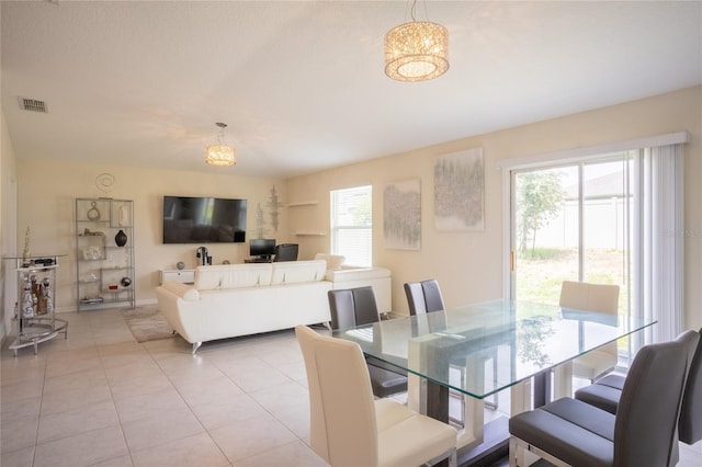 561 Andrea Cir S, Haines City, FL 33844 - dining area featuring a chandelier and light tile patterned floors