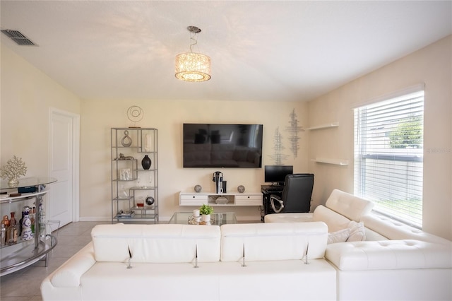561 Andrea Cir S, Haines City, FL 33844 - living room featuring tile patterned floors and a chandelier