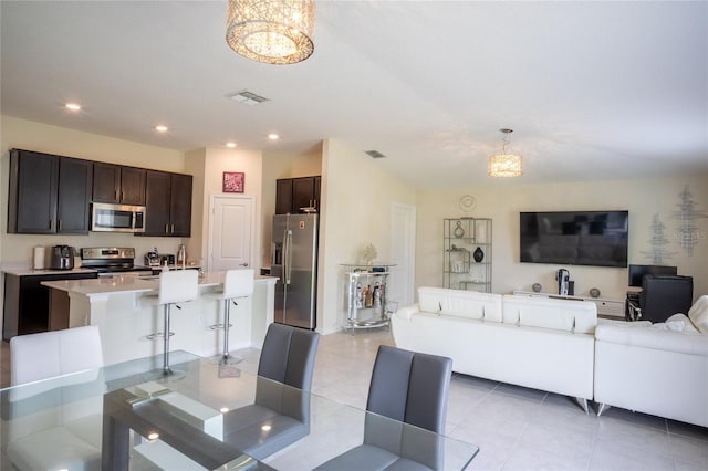561 Andrea Cir S, Haines City, FL 33844 - dining room with a chandelier, light tile patterned floors, and recessed lighting