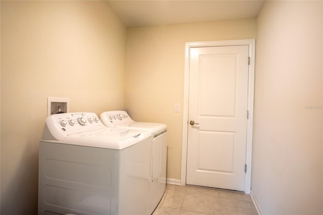 561 Andrea Cir S, Haines City, FL 33844 - laundry area featuring separate washer and dryer and light tile patterned flooring