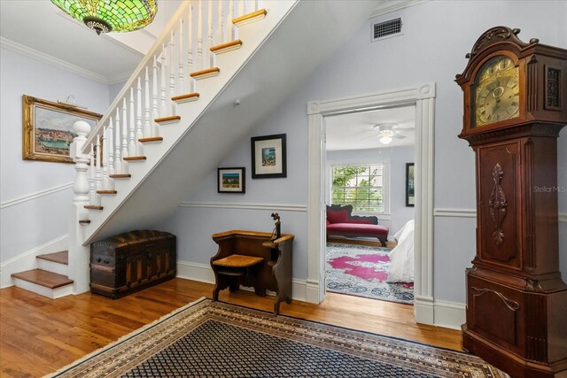 8407 Interbay Blvd, Tampa, FL 33616 - foyer with wood finished floors, stairway, and ornamental molding