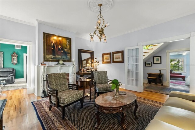 8407 Interbay Blvd, Tampa, FL 33616 - living room with light wood-style floors, crown molding, and a chandelier