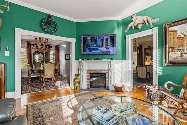 8407 Interbay Blvd, Tampa, FL 33616 - living room with a chandelier, wood finished floors, crown molding, and a fireplace