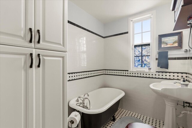 8407 Interbay Blvd, Tampa, FL 33616 - bathroom featuring tile walls and a freestanding bath