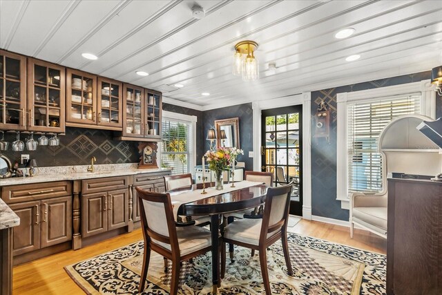 8407 Interbay Blvd, Tampa, FL 33616 - dining room featuring light wood-type flooring, bar with sink, and recessed lighting