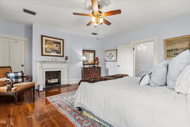 8407 Interbay Blvd, Tampa, FL 33616 - bedroom featuring wood finished floors, a fireplace with flush hearth, and a ceiling fan