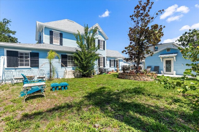 8407 Interbay Blvd, Tampa, FL 33616 - view of front of property featuring a front yard and a shingled roof