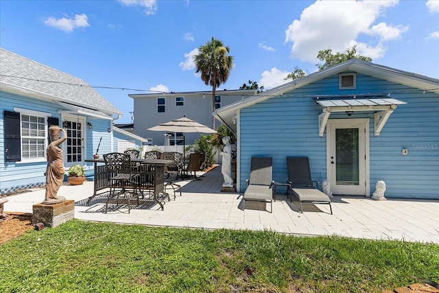 8407 Interbay Blvd, Tampa, FL 33616 - back of house featuring a patio and a lawn