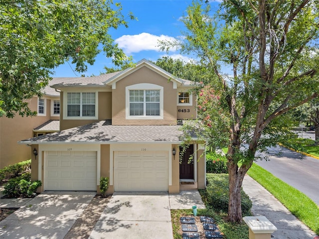 6453 Alcalde Ct Unit 110, Orlando, FL 32835 - multi unit property with stucco siding, driveway, a garage, and a shingled roof