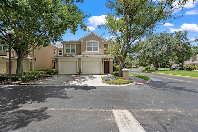 6453 Alcalde Ct Unit 110, Orlando, FL 32835 - view of front of home with concrete driveway, an attached garage, and stucco siding