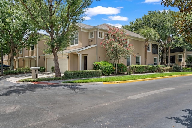 6453 Alcalde Ct Unit 110, Orlando, FL 32835 - multi unit property with an attached garage, stucco siding, and driveway