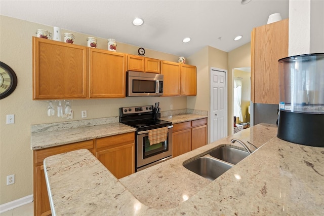 6453 Alcalde Ct Unit 110, Orlando, FL 32835 - kitchen featuring appliances with stainless steel finishes, light stone counters, and recessed lighting