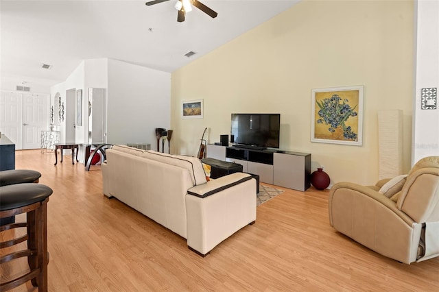 6453 Alcalde Ct Unit 110, Orlando, FL 32835 - living room with light wood-style flooring, ceiling fan, and high vaulted ceiling