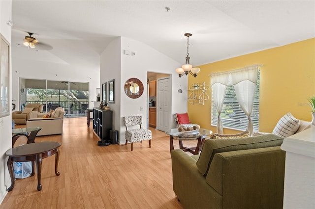 6453 Alcalde Ct Unit 110, Orlando, FL 32835 - living area featuring vaulted ceiling, light wood-type flooring, and a ceiling fan
