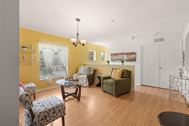 6453 Alcalde Ct Unit 110, Orlando, FL 32835 - living area featuring a chandelier and light wood-style floors