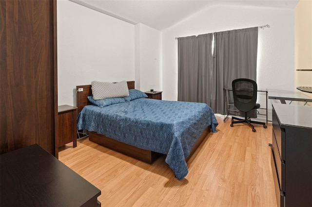 6453 Alcalde Ct Unit 110, Orlando, FL 32835 - bedroom with light wood finished floors and lofted ceiling