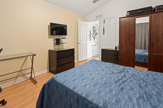 6453 Alcalde Ct Unit 110, Orlando, FL 32835 - bedroom featuring lofted ceiling and light wood-style flooring