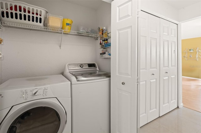 6453 Alcalde Ct Unit 110, Orlando, FL 32835 - washroom featuring separate washer and dryer and light tile patterned floors