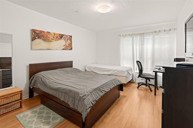 6453 Alcalde Ct Unit 110, Orlando, FL 32835 - bedroom with light wood-style floors and a textured ceiling