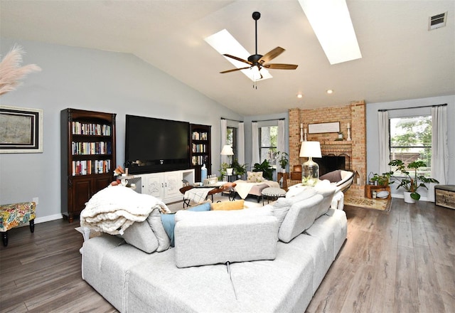 26 Canter Club Ct, Debary, FL 32713 - living area featuring plenty of natural light, vaulted ceiling, a skylight, and wood finished floors