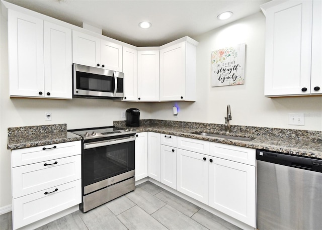 26 Canter Club Ct, Debary, FL 32713 - kitchen featuring stainless steel appliances, recessed lighting, white cabinets, and dark stone counters