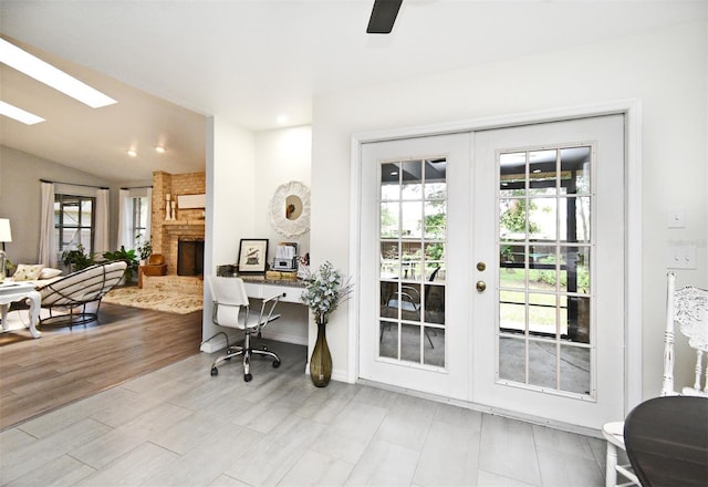 26 Canter Club Ct, Debary, FL 32713 - office space with french doors, a fireplace, a skylight, vaulted ceiling, and wood finished floors