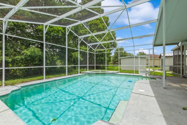 1660 Justin Matthew Way, Saint Cloud, FL 34771 - view of swimming pool featuring a storage unit, a patio, glass enclosure, and a pool with connected hot tub