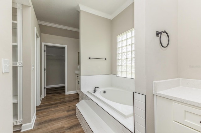 1660 Justin Matthew Way, Saint Cloud, FL 34771 - bathroom with a bath, a walk in closet, crown molding, wood finished floors, and vanity