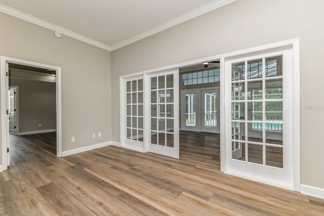 1660 Justin Matthew Way, Saint Cloud, FL 34771 - empty room featuring crown molding, wood finished floors, and french doors