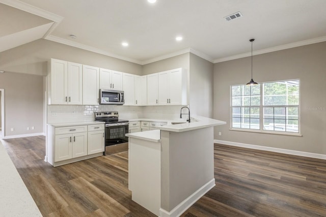1660 Justin Matthew Way, Saint Cloud, FL 34771 - kitchen featuring appliances with stainless steel finishes, white cabinets, backsplash, a peninsula, and recessed lighting