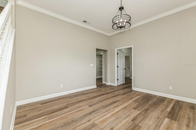 1660 Justin Matthew Way, Saint Cloud, FL 34771 - empty room featuring a chandelier, wood finished floors, and ornamental molding