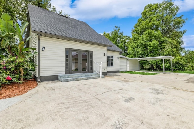 1660 Justin Matthew Way, Saint Cloud, FL 34771 - rear view of house featuring french doors, a shingled roof, and a carport