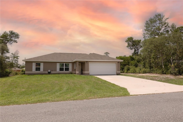 16863 SW 29th Terrace Rd, Ocala, FL 34473 - view of front facade featuring a garage, driveway, a yard, and stucco siding